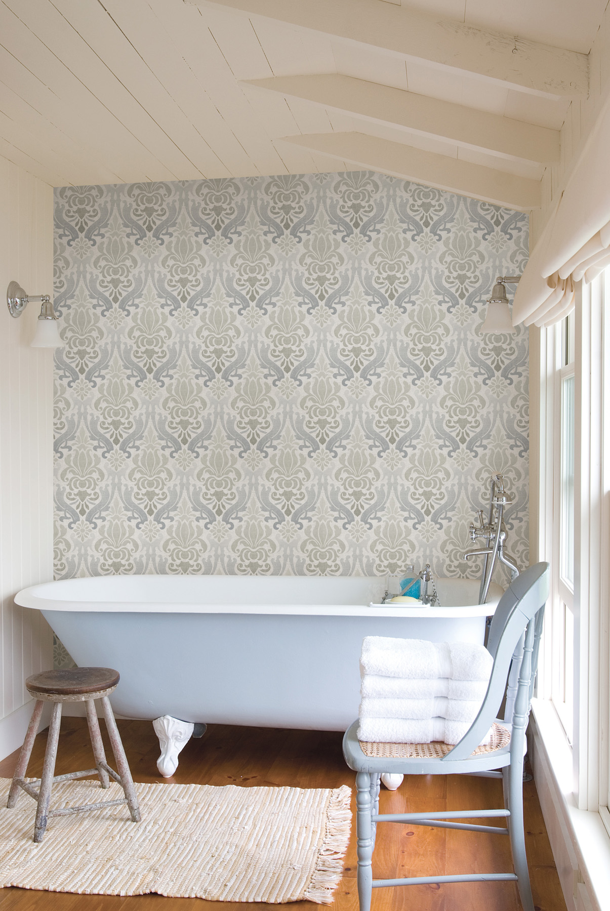 Blue Damask wallpaper feature wall in a bathroom with a clawfoot tub