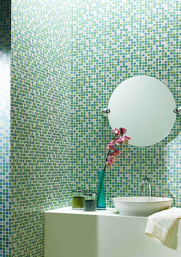 A beautiful sea glass inspired tiled bathroom, created with a textured wallpaper