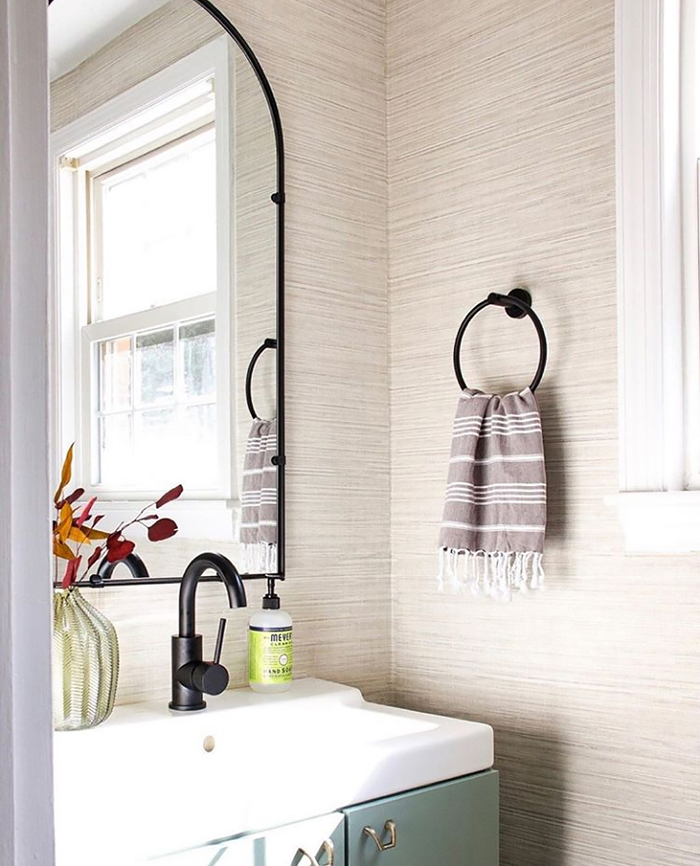 Simple and elegant powder room with grasscloth wallpaper