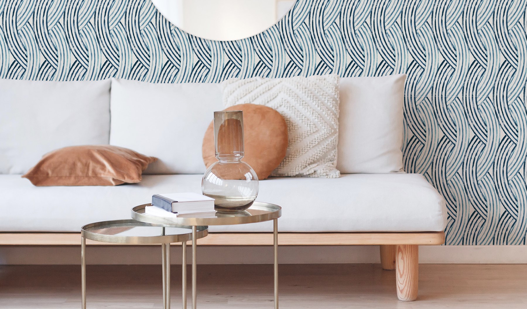 A modern blue geometric wallpaper lies beneath a Scandinavian themed living room