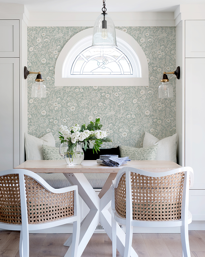 Charming kitchenette style with modern farmhouse decor: pale blue floral wallpaper, caned chairs, and simple balconette